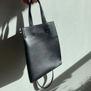 Black leather bucket bag from Opening Ceremony